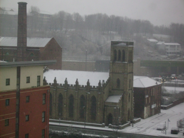 View of a church, with the roof covered in snow